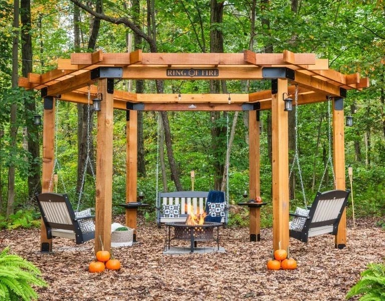 Round cedar pergola over a fire pit and lounge chairs