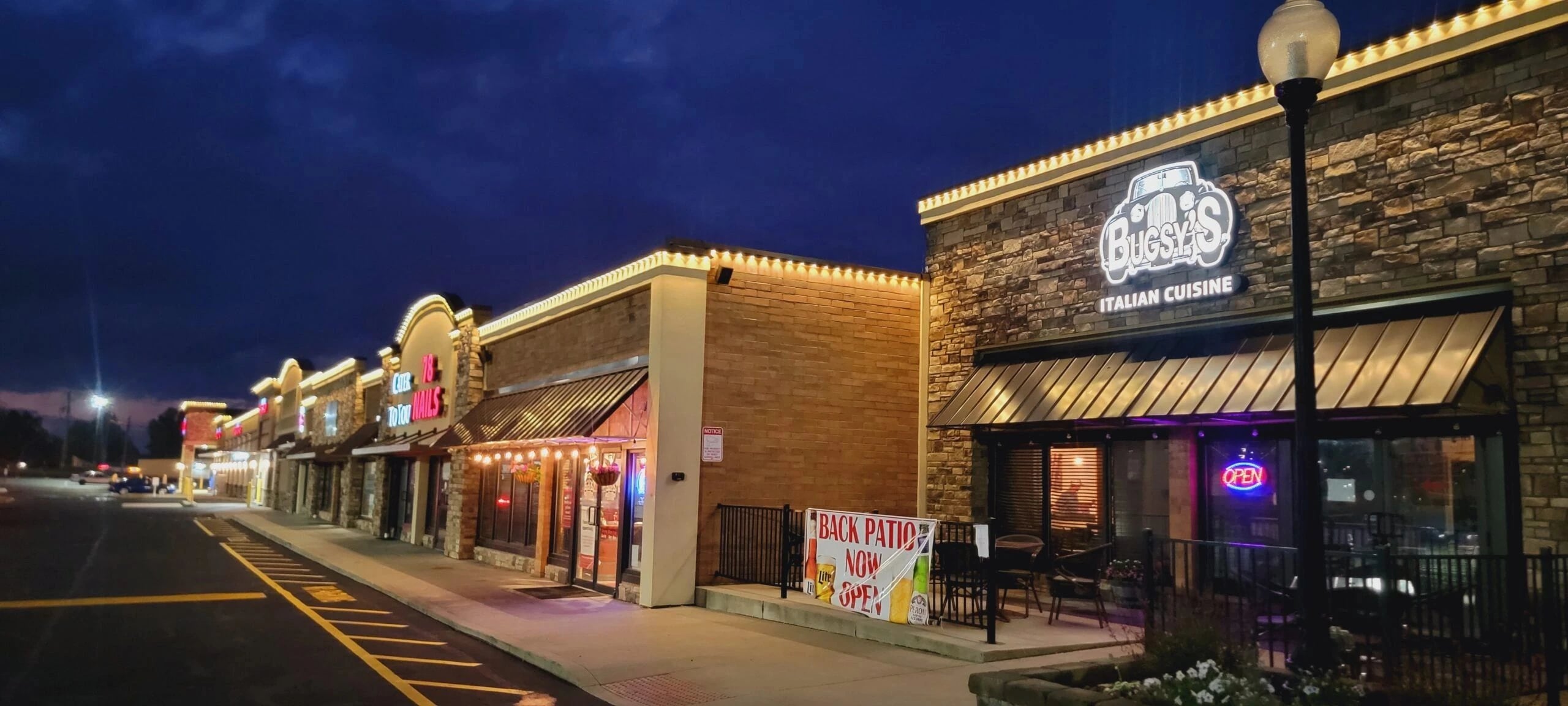 Retail strip outlined in permanent roofline lighting