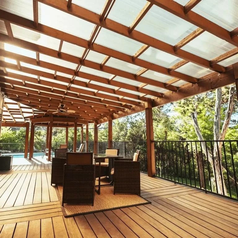 White pergola roof cover over a poolside deck