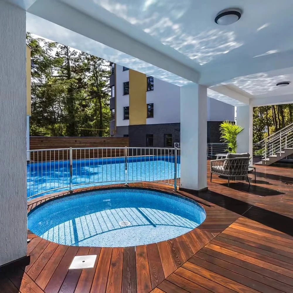 Hot tub set into an ash deck under a covered patio
